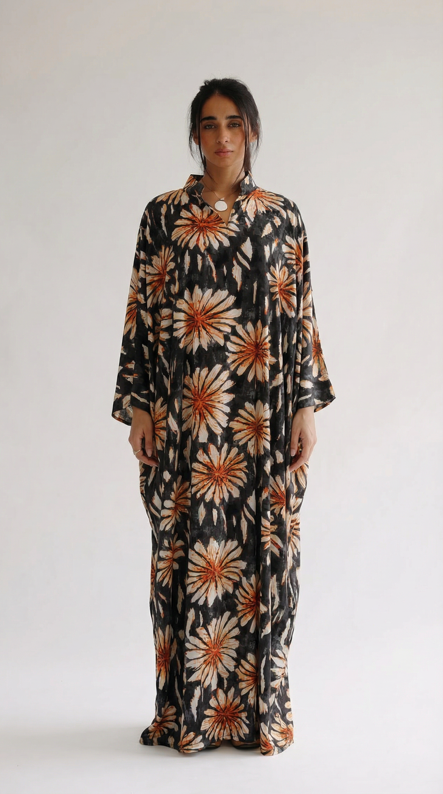 Woman wearing a floral dress with a plain background