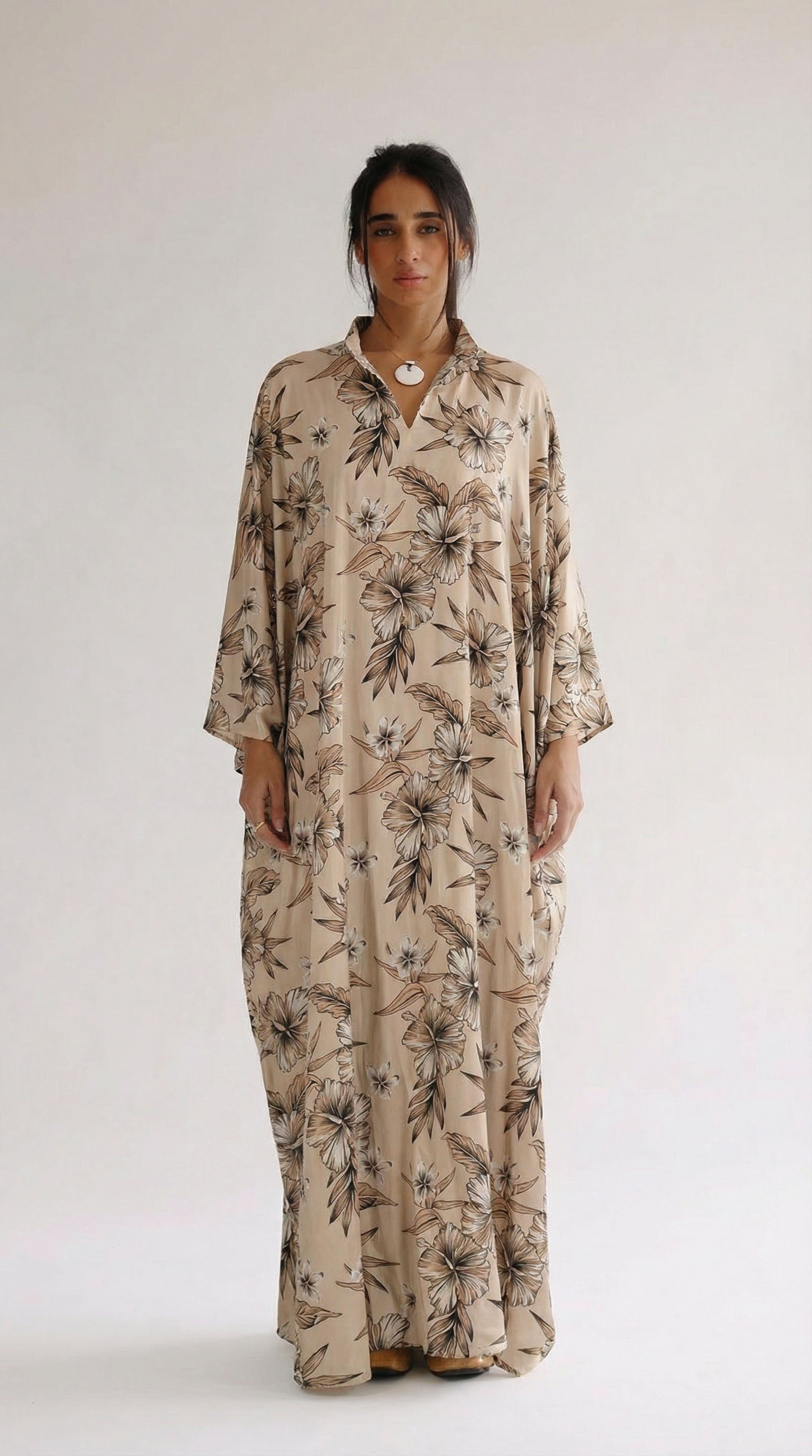 Woman wearing a floral dress on a white background