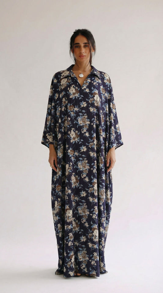 Woman wearing a long floral dress against a white background