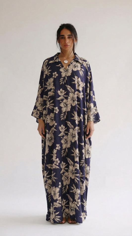 Woman wearing a navy floral dress against a white background