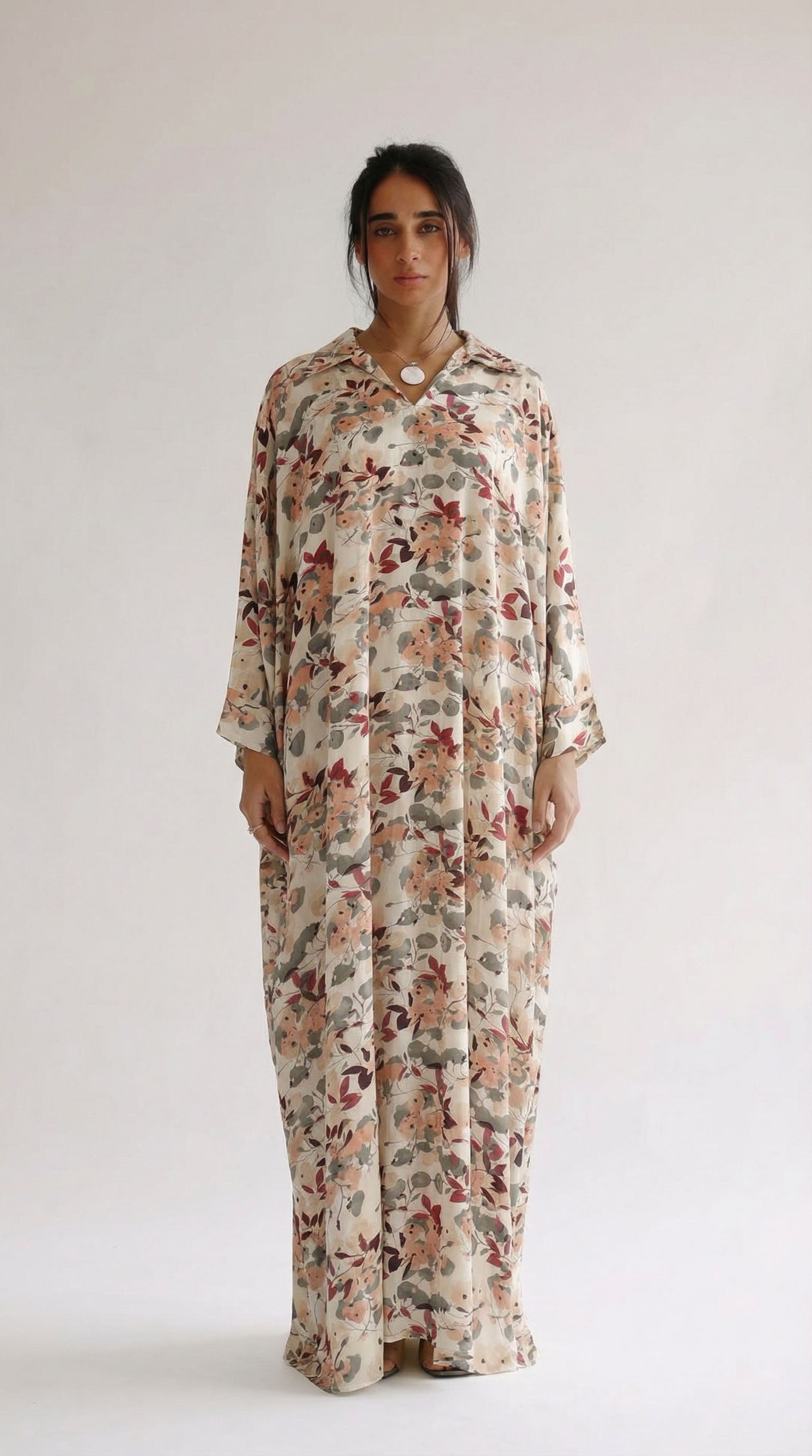 Woman wearing a floral dress against a white background