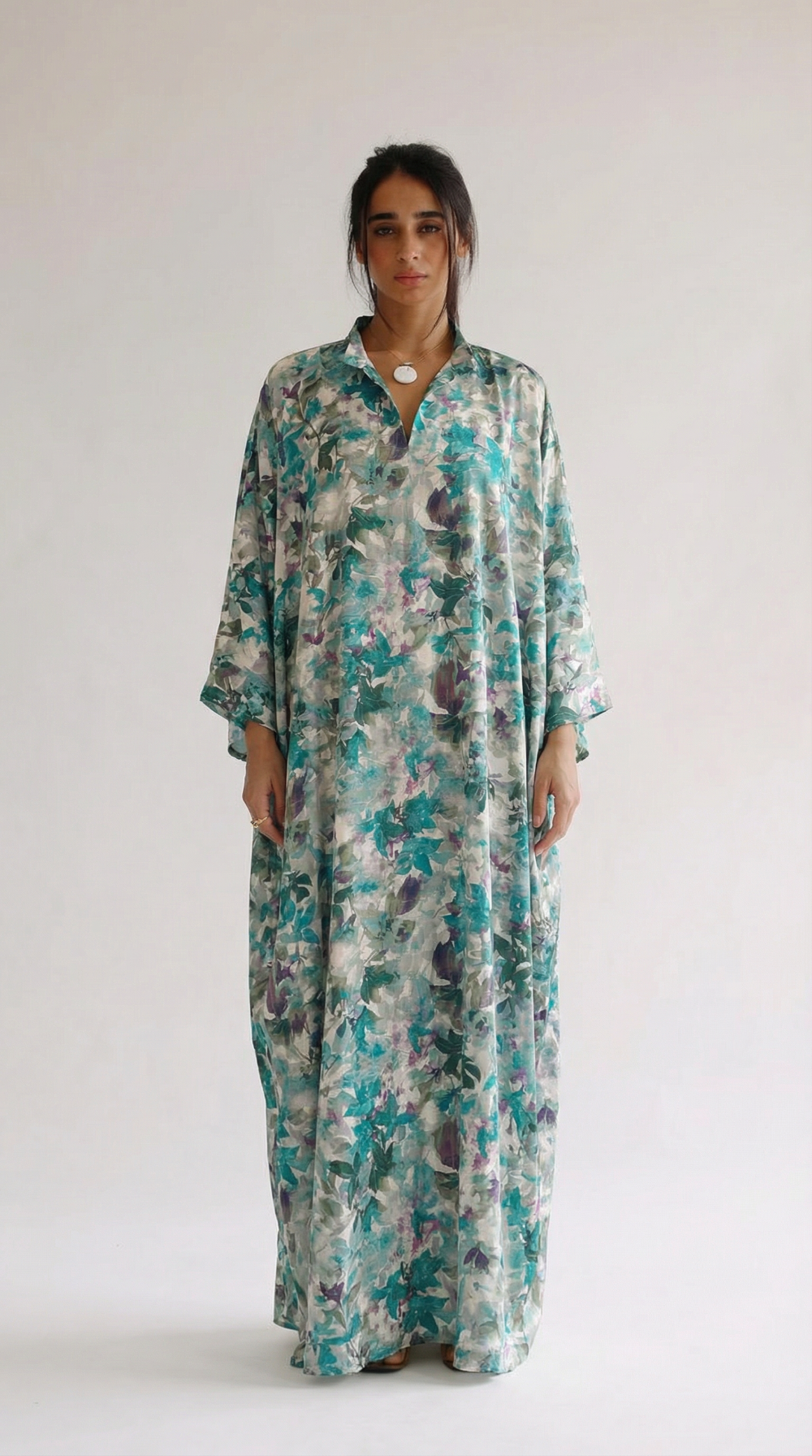 Woman wearing a floral dress against a white background