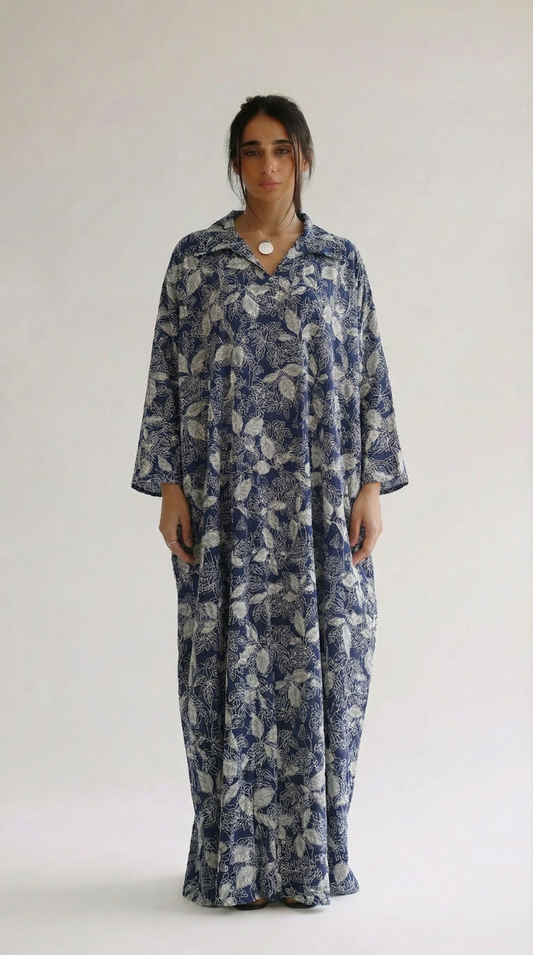 Woman wearing a blue floral dress against a white background