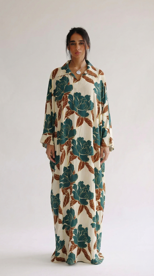 Woman wearing a long floral dress against a white background
