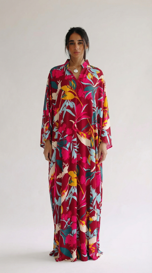 Woman wearing a colorful floral dress against a white background