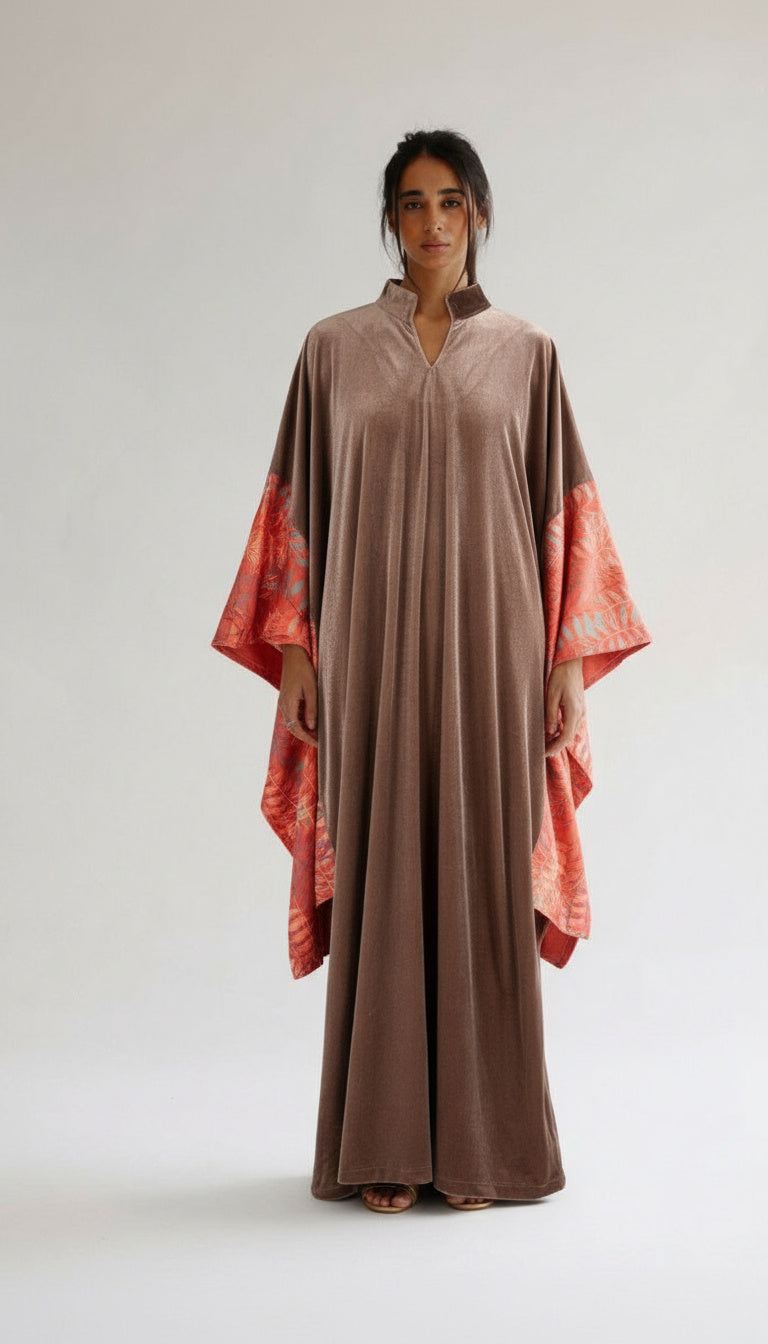 Woman wearing a brown dress with orange accents on a white background