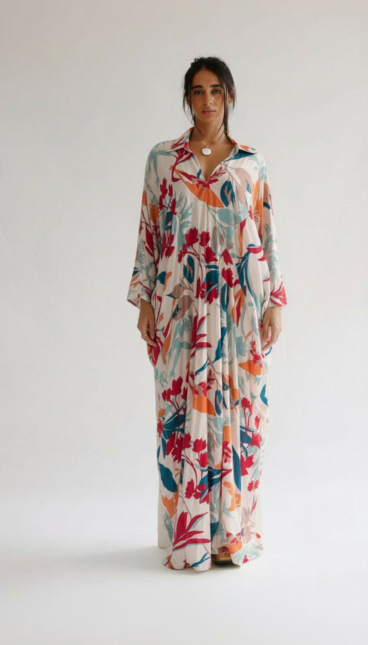 Woman wearing a colorful floral dress on a white background